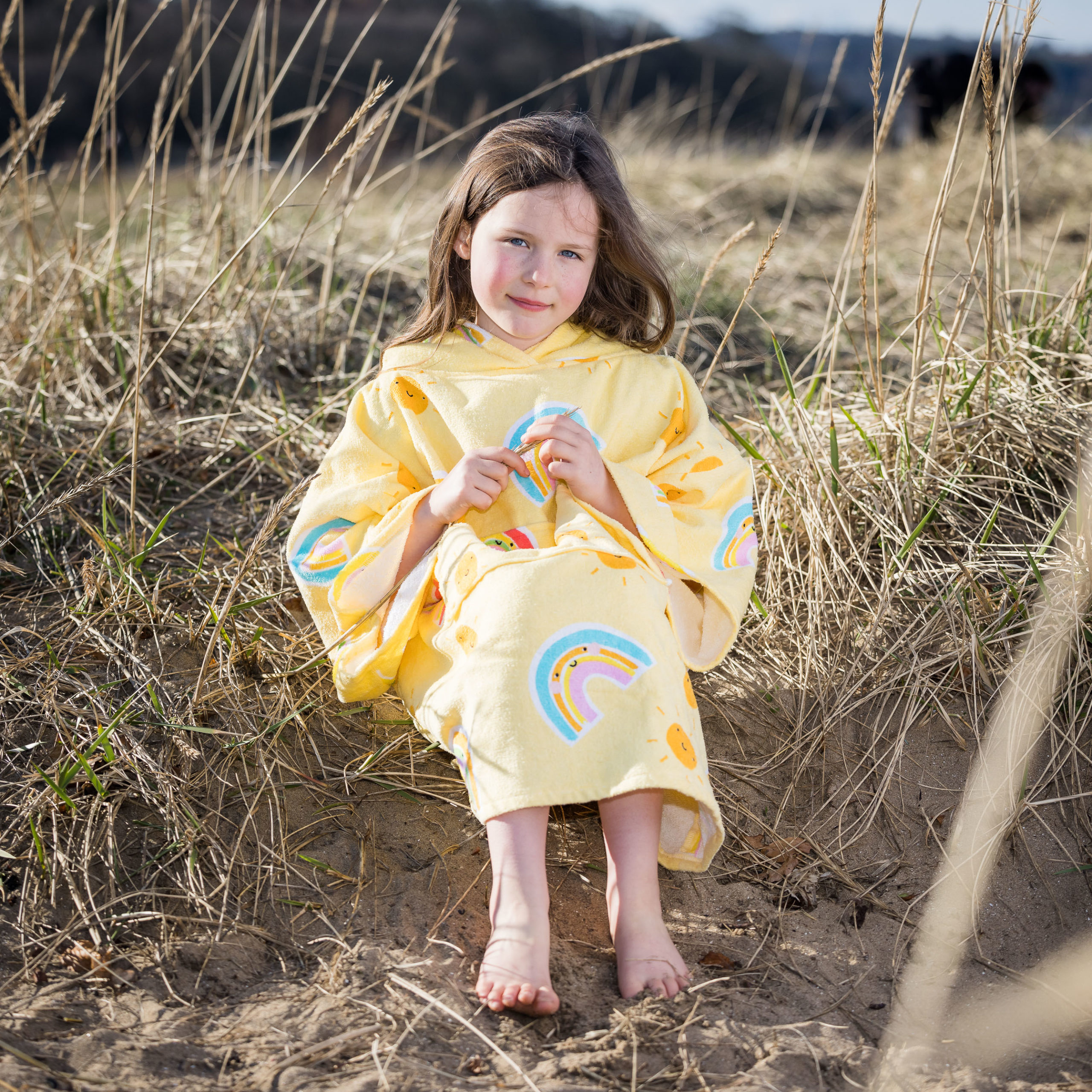 yellow beach poncho with rainbow print