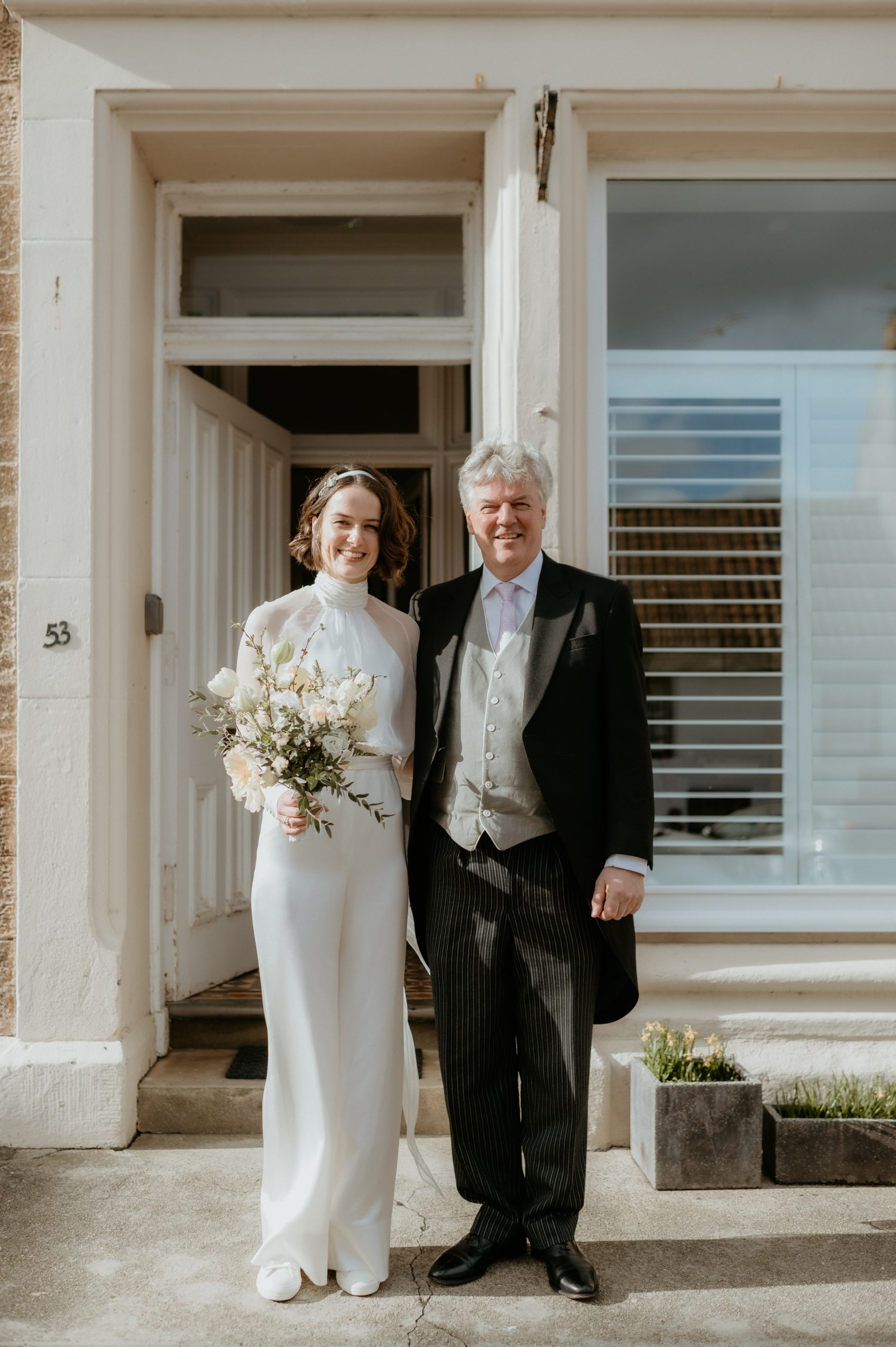 Bride in jumpsuit with her dad