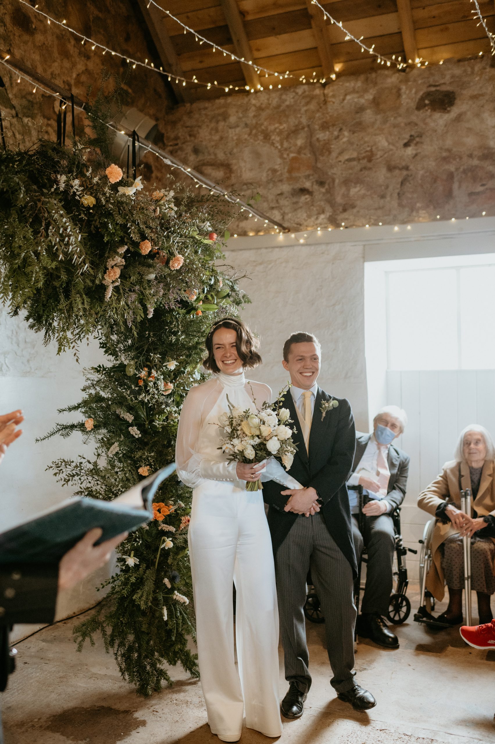 bride in jumpsuit and groom 