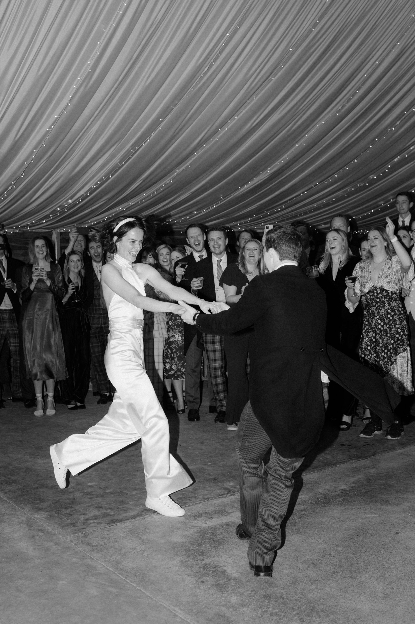 bride in jumpsuit dancing