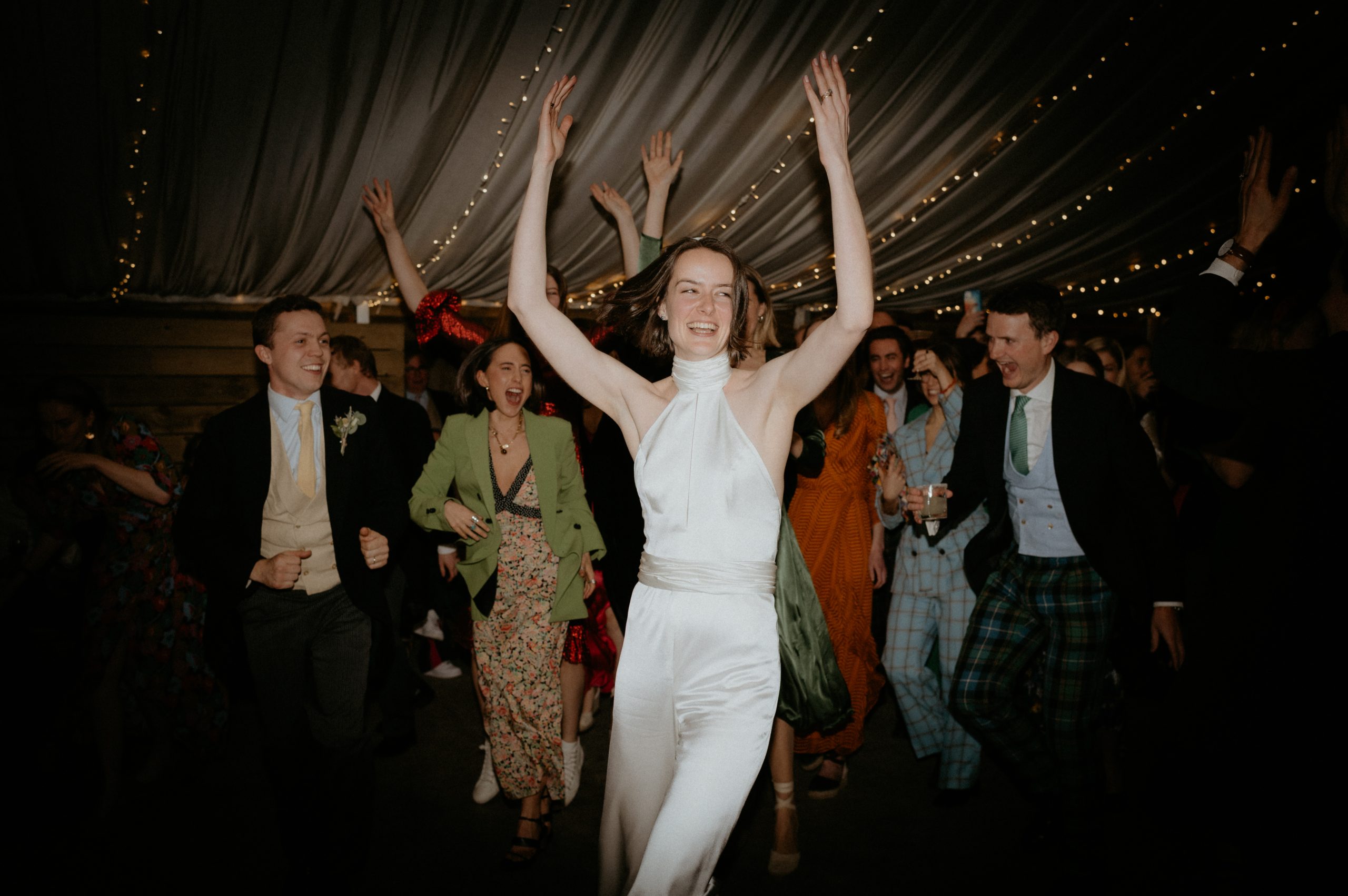 bride in jumpsuit dancing