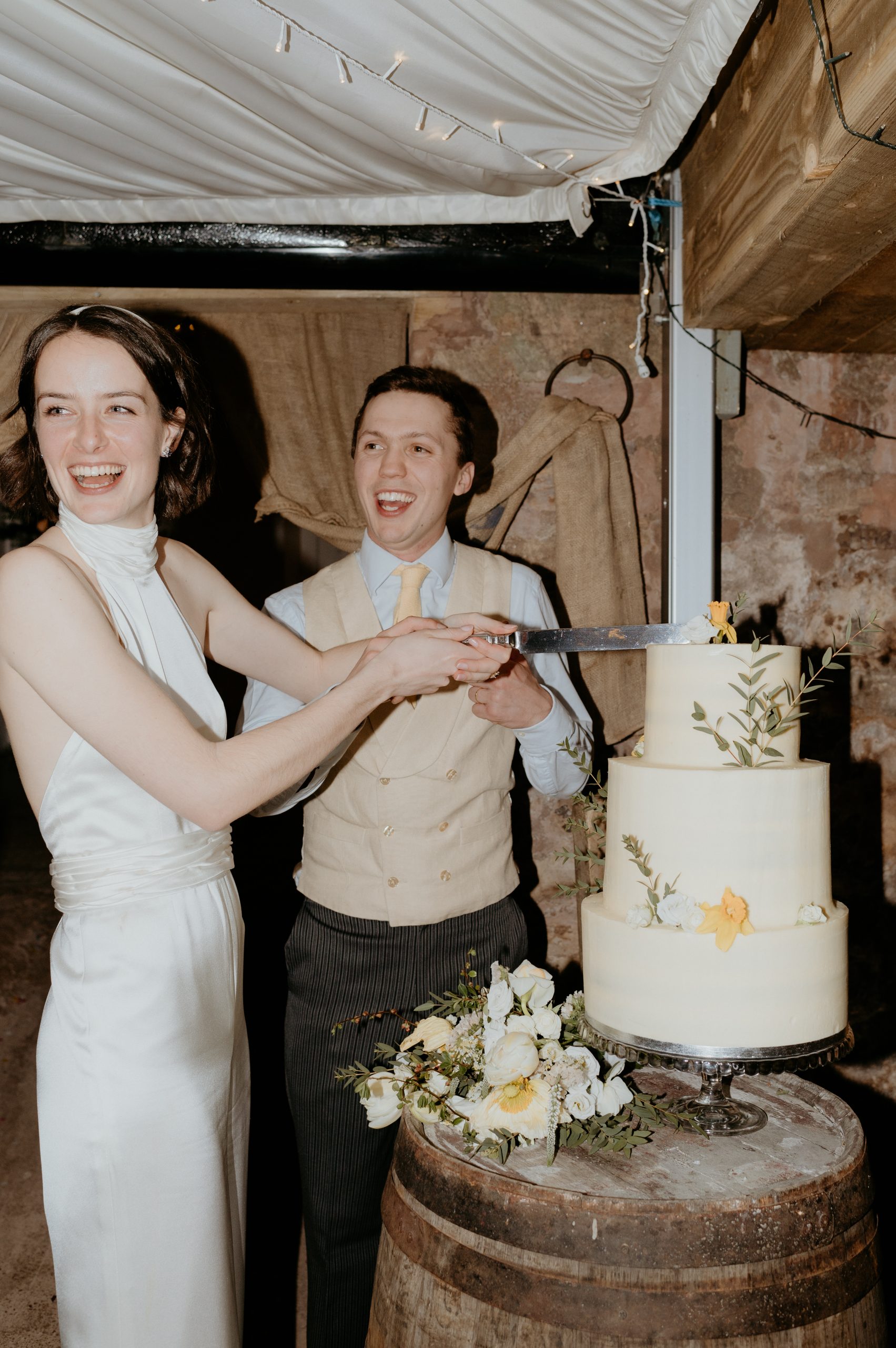 bride and groom cutting the cake