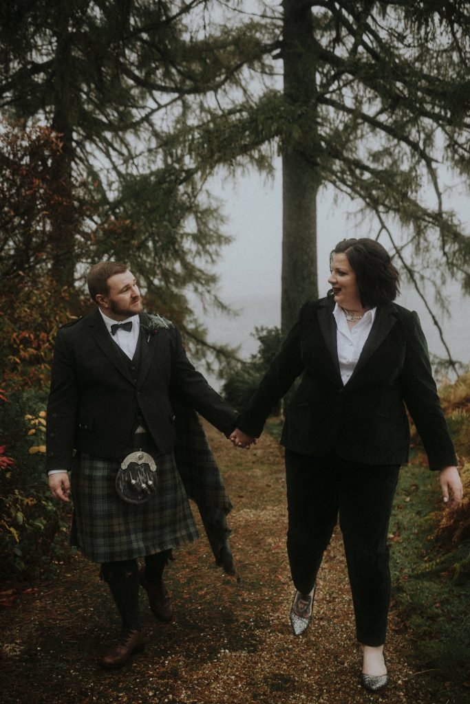 bride and groom at beautiful scottish elopement in Scotland. Bride wearing bespoke dark green velvet suit
