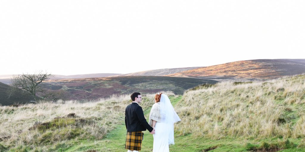 bride and groom in the scottish hills
