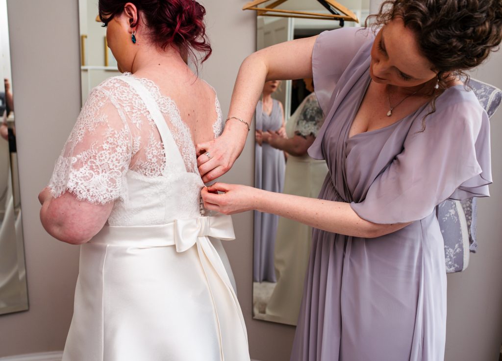 Cover button and belt bow detailing on the back of the dress