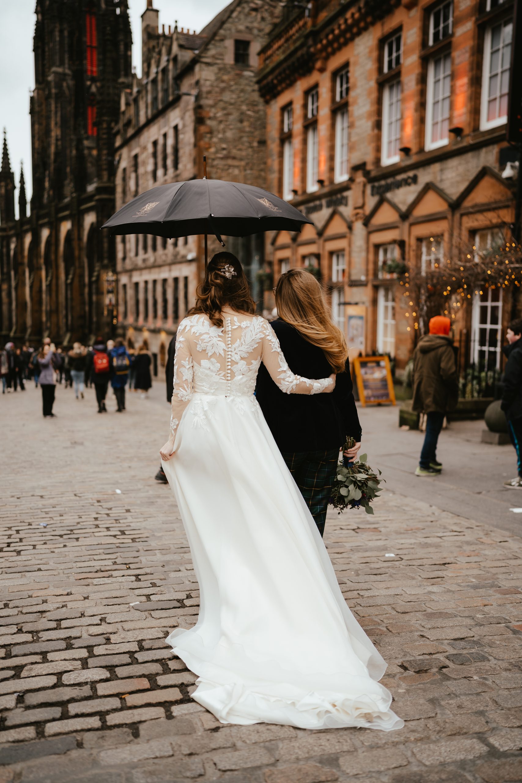 Back view bride in wedding dress, bride in tartan suit,