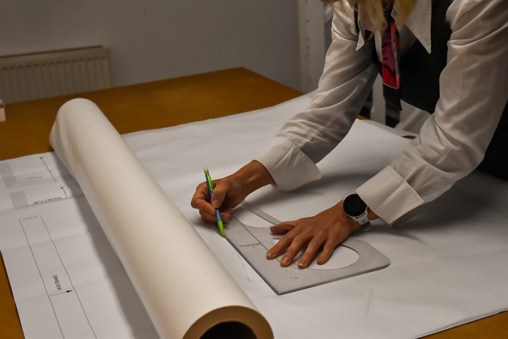 hands drafting dressmaking